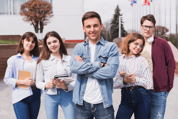 man-surrounded-by-smart-students-with-books-looking-camera_23-2148166282